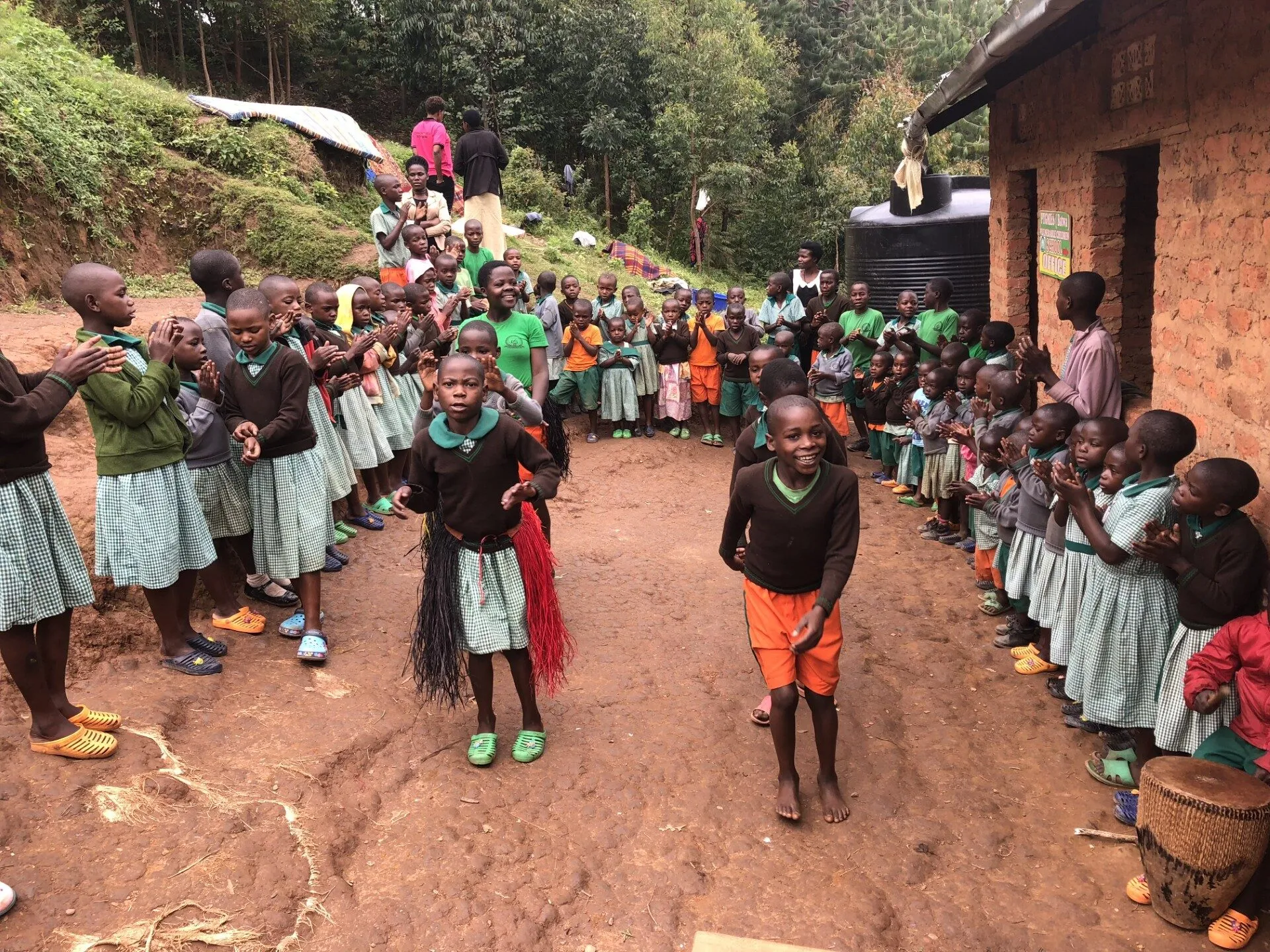 Schoolchildren dancing in a Rwandan village